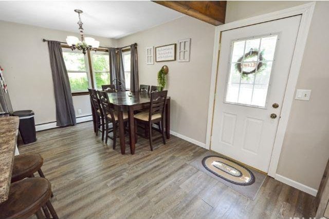 7132 W 350 N, West Lafayette, IN 47906 - dining space with a chandelier, wood finished floors, and baseboard heating