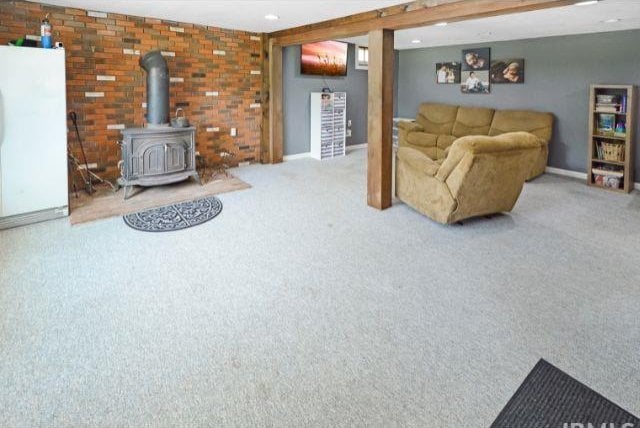 7132 W 350 N, West Lafayette, IN 47906 - living area featuring carpet flooring, a wood stove, and brick wall