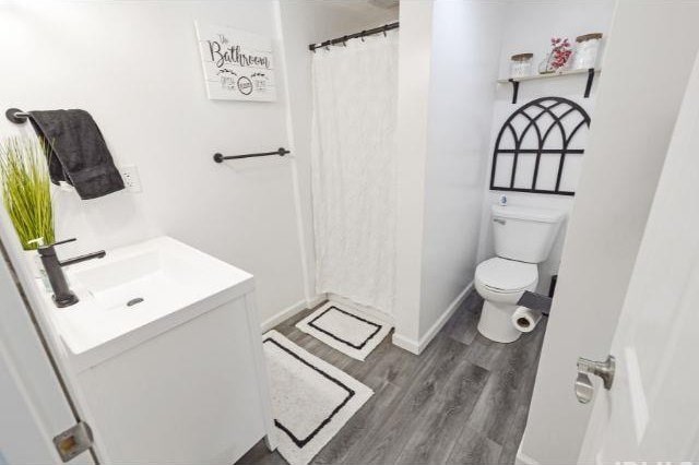 7132 W 350 N, West Lafayette, IN 47906 - bathroom featuring vanity, wood finished floors, and a shower with shower curtain