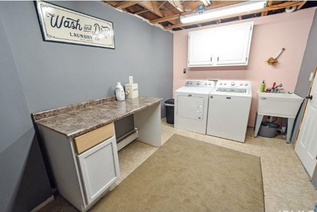 7132 W 350 N, West Lafayette, IN 47906 - laundry room featuring washing machine and dryer, cabinet space, and a baseboard radiator