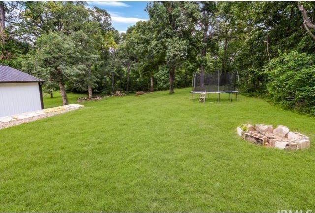 7132 W 350 N, West Lafayette, IN 47906 - view of grassy yard with a trampoline