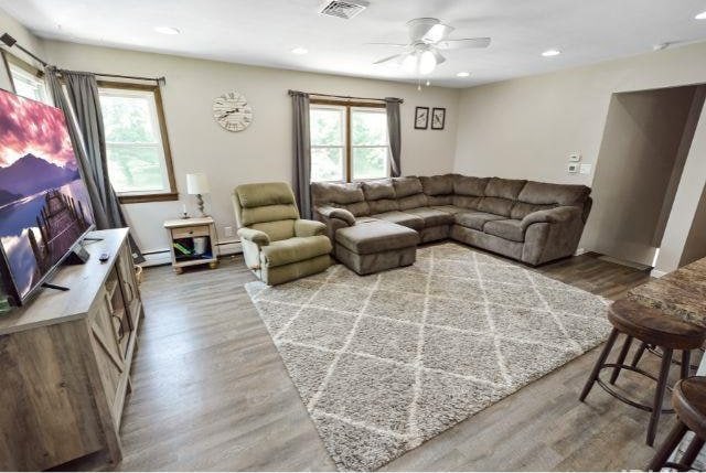 7132 W 350 N, West Lafayette, IN 47906 - living room with wood finished floors, ceiling fan, baseboard heating, and recessed lighting