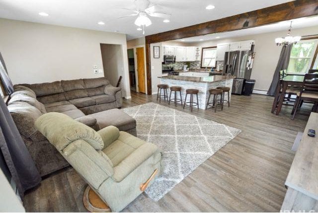 7132 W 350 N, West Lafayette, IN 47906 - living area with ceiling fan, recessed lighting, wood finished floors, a baseboard heating unit, and a chandelier