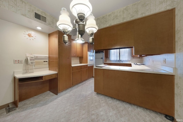 1202 Park Ave, New Haven, IN 46774 - kitchen with brown cabinets, freestanding refrigerator, wallpapered walls, light countertops, and a peninsula