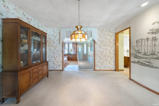 1202 Park Ave, New Haven, IN 46774 - unfurnished dining area featuring wallpapered walls, light carpet, and a chandelier