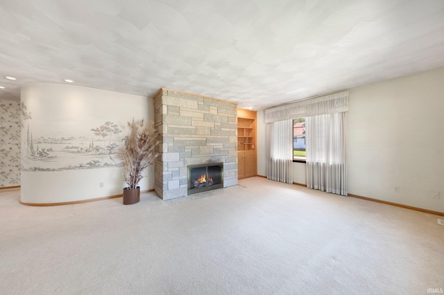 1202 Park Ave, New Haven, IN 46774 - unfurnished living room featuring carpet floors and a stone fireplace