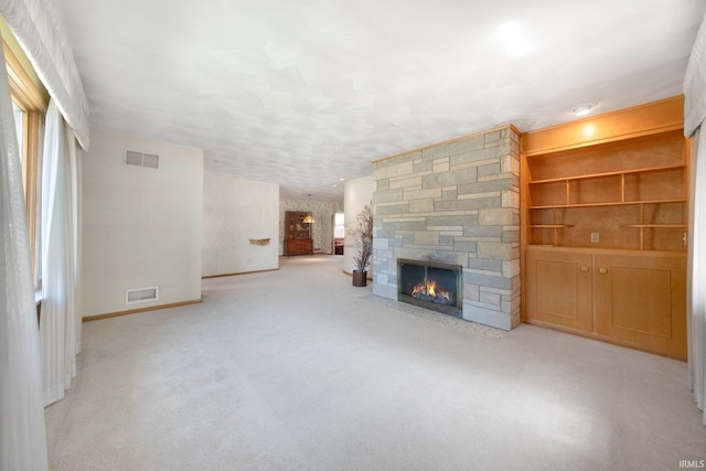 1202 Park Ave, New Haven, IN 46774 - unfurnished living room featuring a stone fireplace and carpet flooring