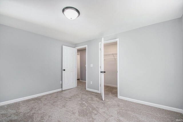 10059 Jefferson Rd, Osceola, IN 46561 - unfurnished bedroom featuring light colored carpet, a spacious closet, and a closet