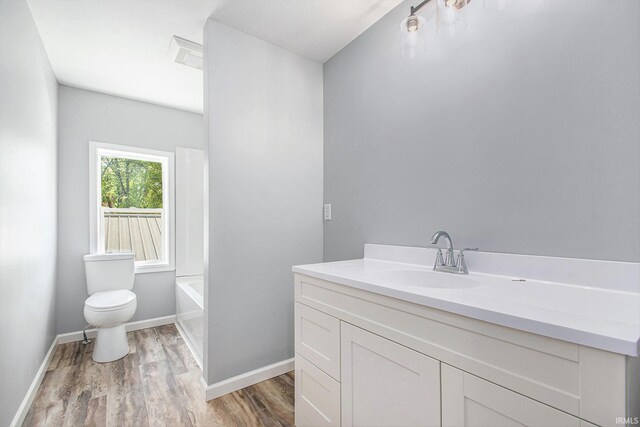 10059 Jefferson Rd, Osceola, IN 46561 - full bathroom with wood finished floors, vanity, and a tub