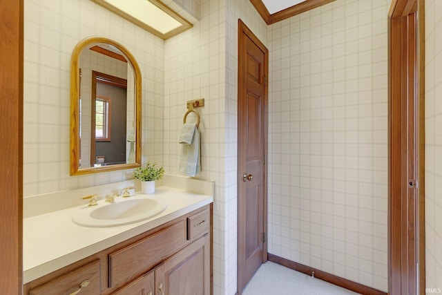 1102 Cabriolet Blvd, Auburn, IN 46706 - bathroom featuring vanity, wallpapered walls, and ornamental molding