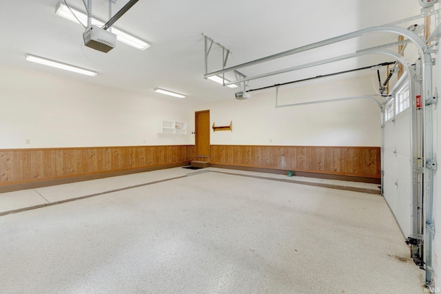 1102 Cabriolet Blvd, Auburn, IN 46706 - garage with a garage door opener, wainscoting, and wood walls