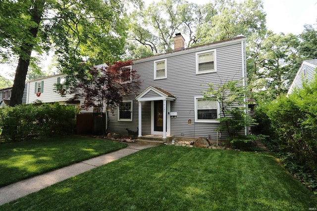 1015 W Battell St, South Bend, IN 46545 - view of front facade featuring a chimney and a front lawn