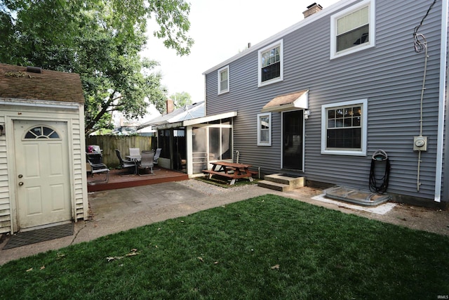 1015 W Battell St, South Bend, IN 46545 - back of house featuring a wooden deck, a sunroom, a chimney, and a storage shed