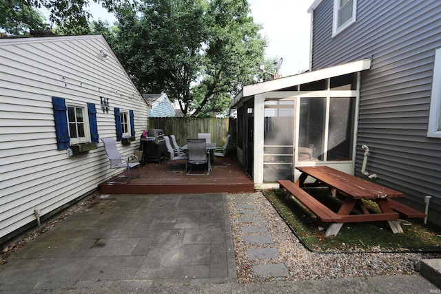 1015 W Battell St, South Bend, IN 46545 - view of patio featuring a sunroom, a wooden deck, outdoor dining space, and a grill