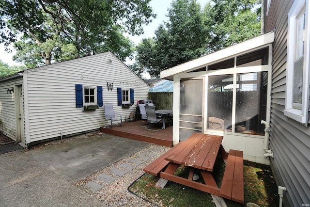 1015 W Battell St, South Bend, IN 46545 - rear view of property featuring outdoor dining space, a sunroom, a wooden deck, and a patio area