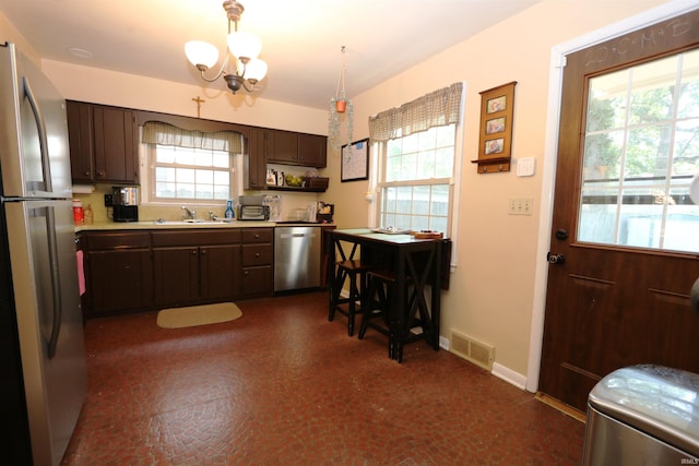 1015 W Battell St, South Bend, IN 46545 - kitchen featuring appliances with stainless steel finishes, plenty of natural light, light countertops, and a chandelier