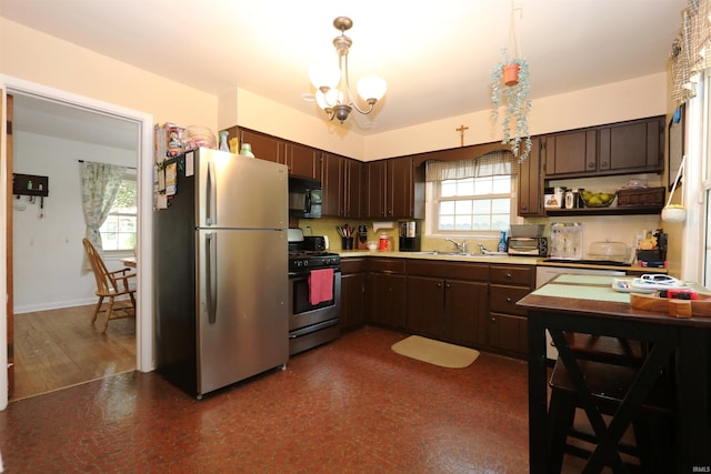 1015 W Battell St, South Bend, IN 46545 - kitchen featuring stainless steel appliances, dark brown cabinetry, light countertops, hanging light fixtures, and open shelves