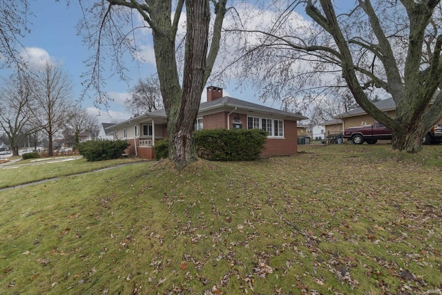 2714 Erskine Blvd, South Bend, IN 46614 - view of front of house with brick siding, a chimney, and a front lawn