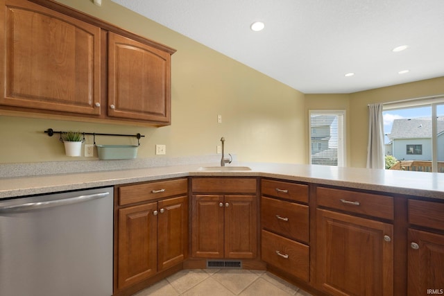 12828 Palazzo Blvd, Fort Wayne, IN 46845 - kitchen featuring stainless steel dishwasher, brown cabinetry, light countertops, recessed lighting, and light tile patterned floors