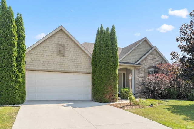 12828 Palazzo Blvd, Fort Wayne, IN 46845 - view of front of house with concrete driveway, stone siding, an attached garage, a front lawn, and roof with shingles