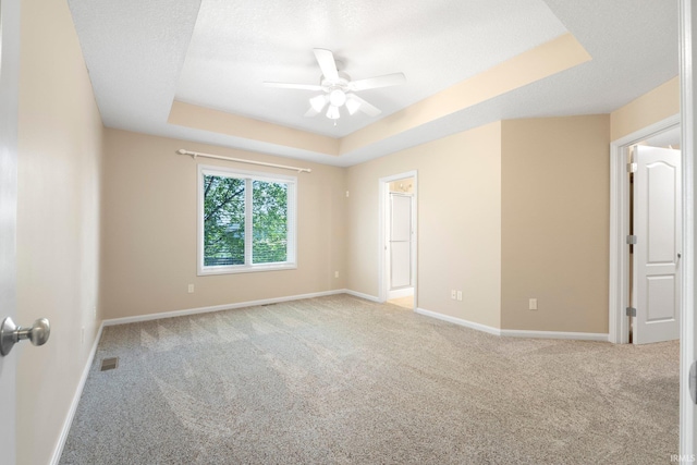 12828 Palazzo Blvd, Fort Wayne, IN 46845 - empty room with a tray ceiling, ceiling fan, and light carpet