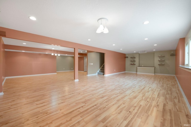 12828 Palazzo Blvd, Fort Wayne, IN 46845 - unfurnished living room featuring light wood-style floors, stairs, and recessed lighting