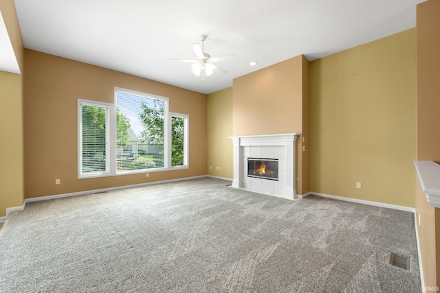 12828 Palazzo Blvd, Fort Wayne, IN 46845 - unfurnished living room featuring a ceiling fan, carpet, and a tiled fireplace