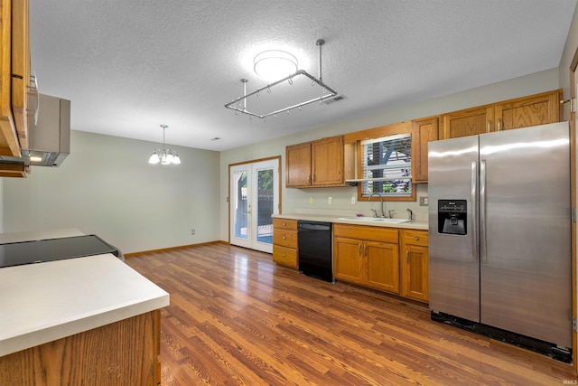 12531 Stoneboro Ct, Fort Wayne, IN 46845 - kitchen featuring stainless steel fridge, black dishwasher, brown cabinets, light countertops, and a textured ceiling