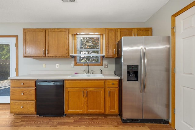 12531 Stoneboro Ct, Fort Wayne, IN 46845 - kitchen with stainless steel fridge with ice dispenser, black dishwasher, wood finished floors, and light countertops
