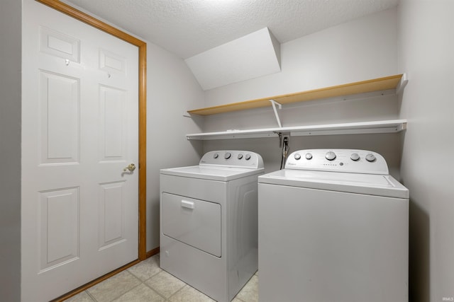 12531 Stoneboro Ct, Fort Wayne, IN 46845 - laundry room with separate washer and dryer, a textured ceiling, and light tile patterned flooring