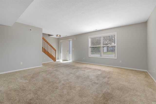 12531 Stoneboro Ct, Fort Wayne, IN 46845 - spare room with stairway, light carpet, and a textured ceiling