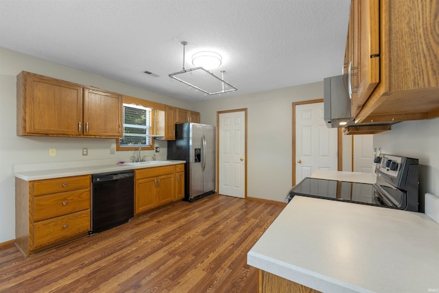 12531 Stoneboro Ct, Fort Wayne, IN 46845 - kitchen with black appliances, dark wood-type flooring, brown cabinets, light countertops, and a textured ceiling