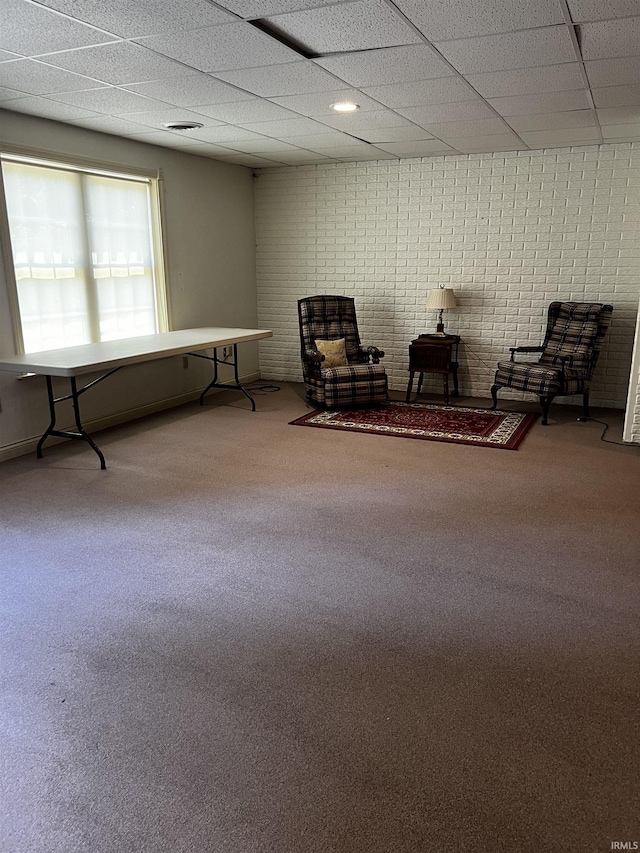 348 N Birdie Ln, Montgomery, IN 47558 - living area with a paneled ceiling, carpet flooring, and brick wall