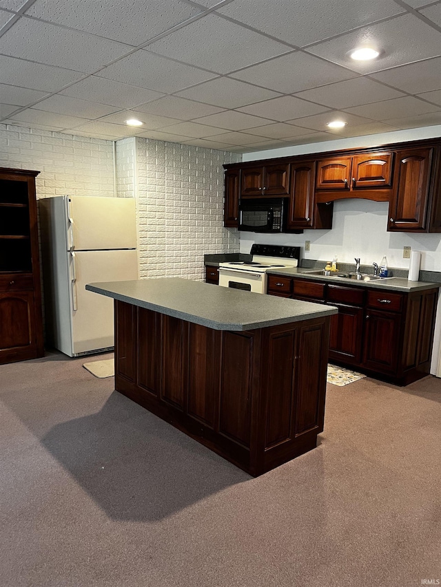 348 N Birdie Ln, Montgomery, IN 47558 - kitchen with white appliances, a center island, dark brown cabinets, a paneled ceiling, and light carpet