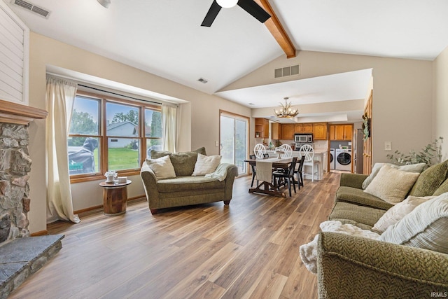 9026 Wallen Ln, Fort Wayne, IN 46825 - living room featuring washer and dryer, a chandelier, light wood-style floors, a fireplace, and ceiling fan