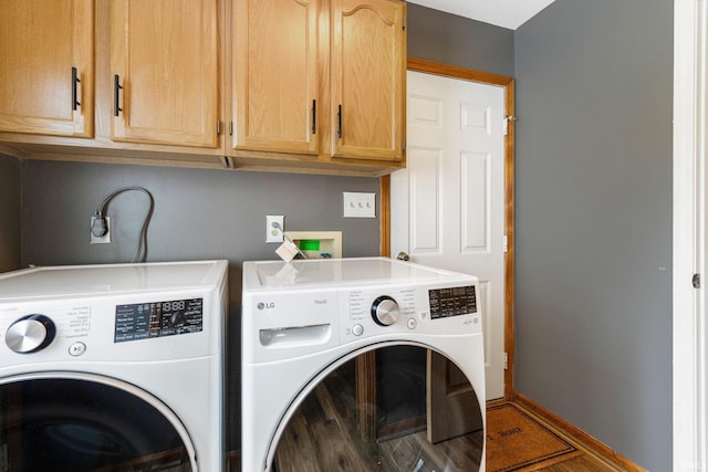 9026 Wallen Ln, Fort Wayne, IN 46825 - laundry area with separate washer and dryer, cabinet space, and wood finished floors