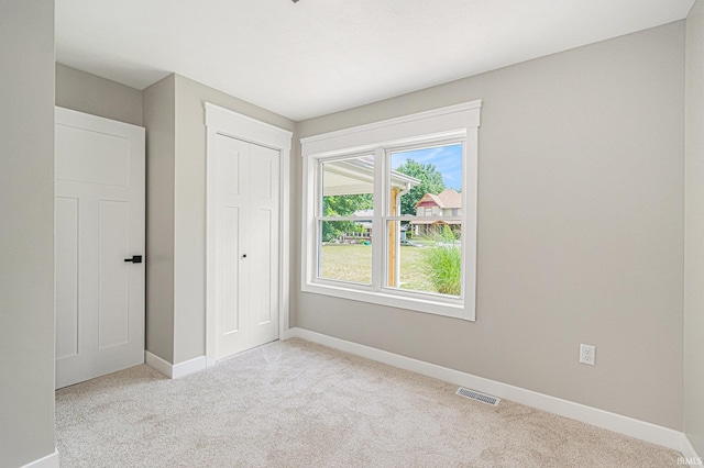 121 W Front St, New Carlisle, IN 46552 - unfurnished bedroom featuring light colored carpet and a closet