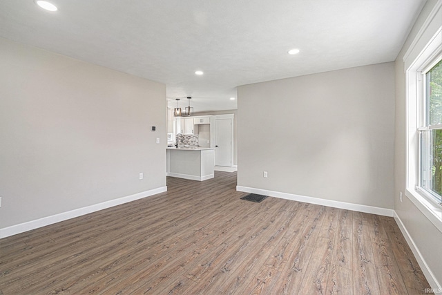 121 W Front St, New Carlisle, IN 46552 - unfurnished living room featuring wood finished floors and recessed lighting