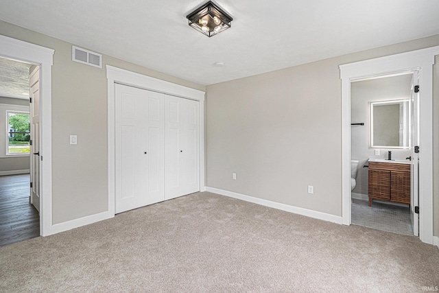 121 W Front St, New Carlisle, IN 46552 - unfurnished bedroom with carpet flooring, a closet, and connected bathroom