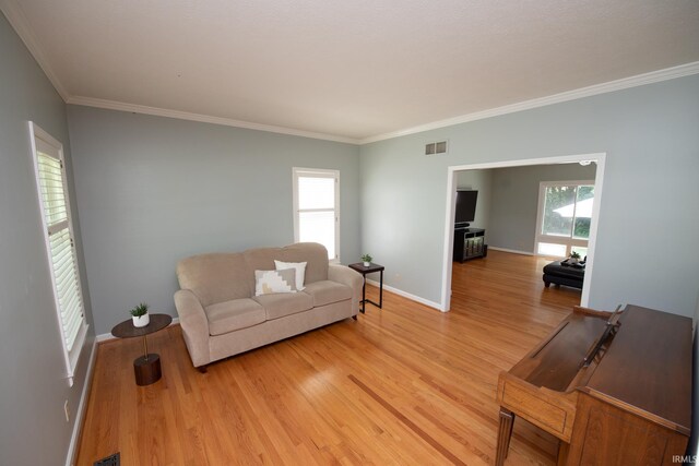 3801 W Capilano Dr, West Lafayette, IN 47906 - living room featuring light wood-type flooring and crown molding