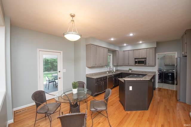 3801 W Capilano Dr, West Lafayette, IN 47906 - kitchen with appliances with stainless steel finishes, washing machine and clothes dryer, gray cabinets, a center island, and recessed lighting