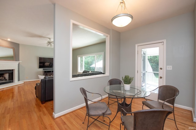 3801 W Capilano Dr, West Lafayette, IN 47906 - dining space featuring light wood finished floors, ceiling fan, and a fireplace