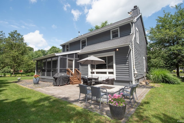 3801 W Capilano Dr, West Lafayette, IN 47906 - rear view of house featuring a sunroom, a patio, a lawn, an outdoor fire pit, and a chimney