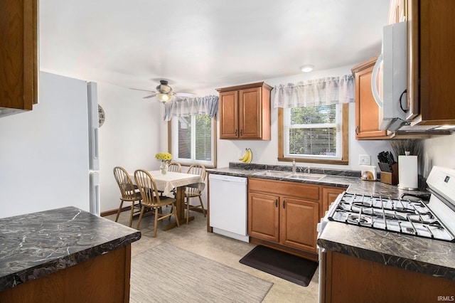 825 W Catalpa Dr, Mishawaka, IN 46545 - kitchen featuring white appliances, dark countertops, ceiling fan, and brown cabinets