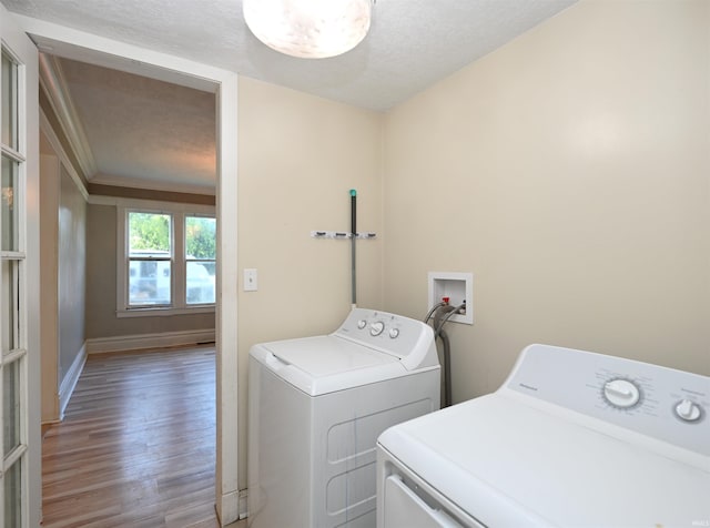 421 S Franklin St, Winamac, IN 46996 - washroom featuring washing machine and dryer, wood finished floors, a textured ceiling, and ornamental molding