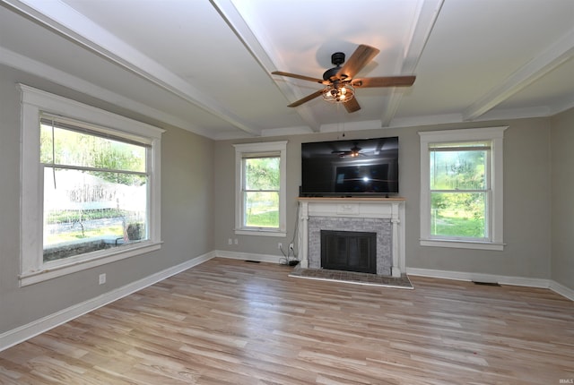 421 S Franklin St, Winamac, IN 46996 - unfurnished living room with beam ceiling, light wood-style floors, a ceiling fan, and a stone fireplace