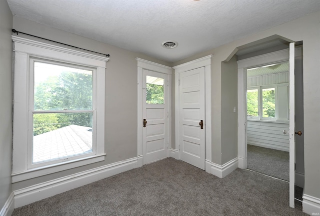 421 S Franklin St, Winamac, IN 46996 - carpeted entrance foyer with baseboards and a textured ceiling