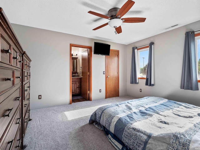 803 Larkwillow Ct, Huntertown, IN 46748 - carpeted bedroom with multiple windows, ceiling fan, and connected bathroom