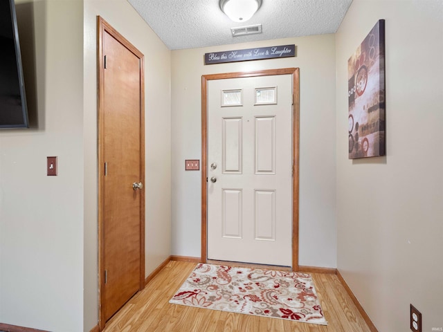 803 Larkwillow Ct, Huntertown, IN 46748 - foyer entrance featuring light wood-type flooring and a textured ceiling