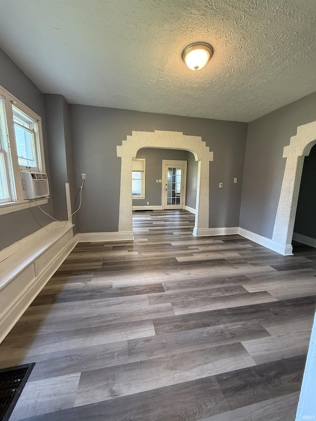 628 Birdsell St, South Bend, IN 46628 - spare room with arched walkways, wood finished floors, a textured ceiling, and cooling unit